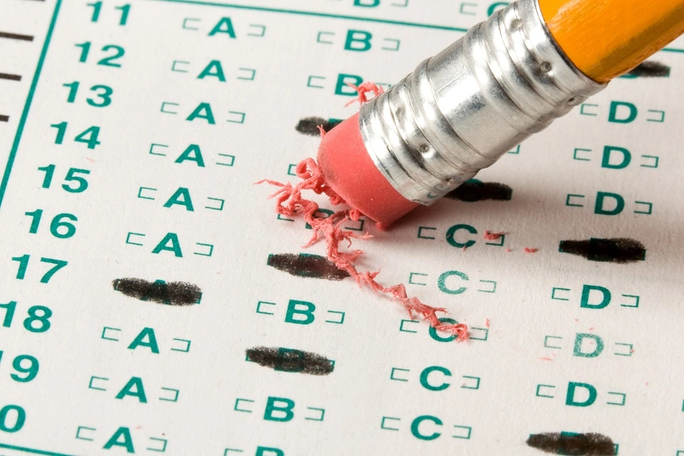 Erasing an answer on a test paper.