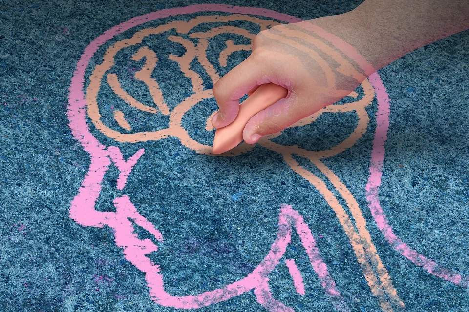 A child drawing a brain with chalk.